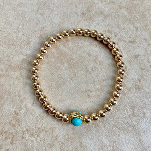 GOLD BEADS WITH TURQUOISE CENTER